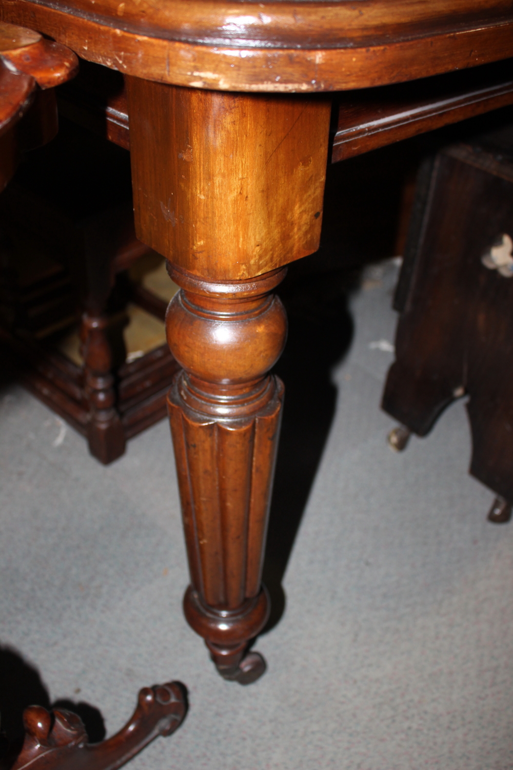A William IV period mahogany extending table, fitted two leaves, on turned and reeded supports, - Image 3 of 3