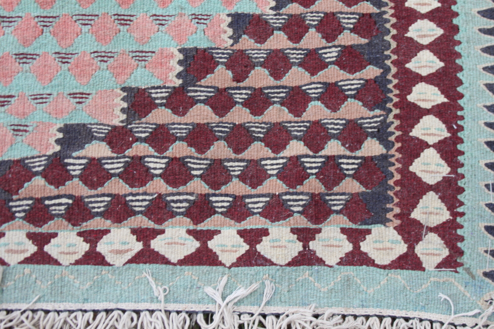 A kelim rug decorated three lozenges on a red ground, 70" x 45" approx - Image 2 of 4