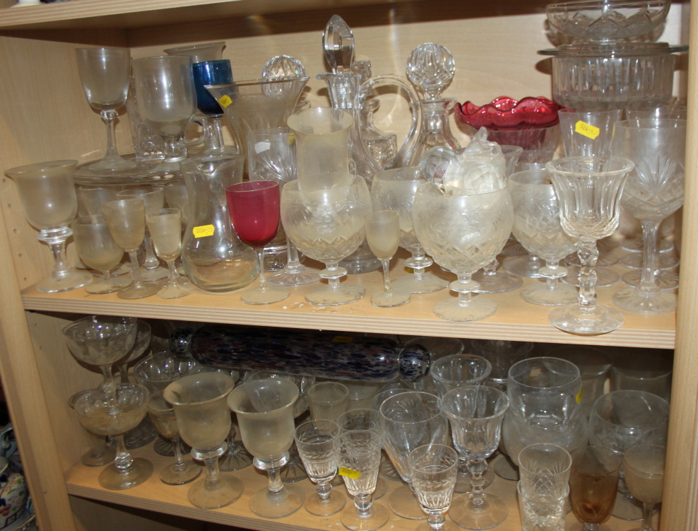 A quantity of glassware, including six champagne flutes, brandy balloons, tumblers, jugs, a cake