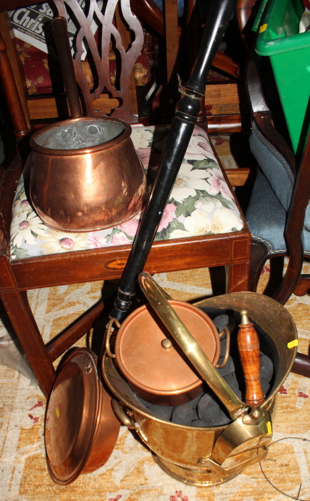 A brass helmet coal scuttle, a copper warming pan, a copper saucepan and lid and a brass bell