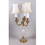 A gilt metal three-light candelabrum with cut glass body fitted electric light