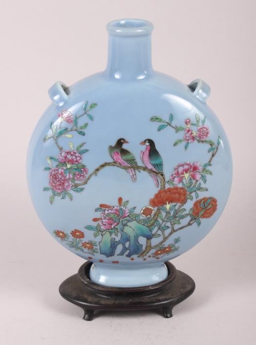 A Chinese moon flask with famille rose decoration of birds and flora, 9 1/2" high, with hardwood