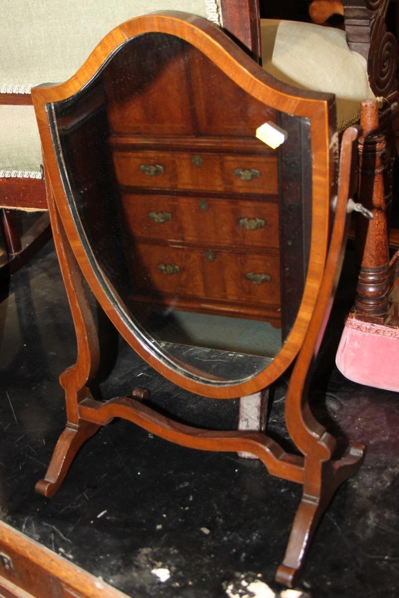 A late 19th century mahogany and box strung shield-shaped swing frame toilet mirror, on skeleton