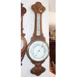 A Victorian aneroid barometer and thermometer, in carved oak case, 31" high