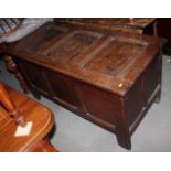 A 17th century oak coffer with plain three panel front and lid, 50" wide