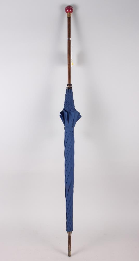 A lady's parasol with blue cover, Malacca shaft and china pommel