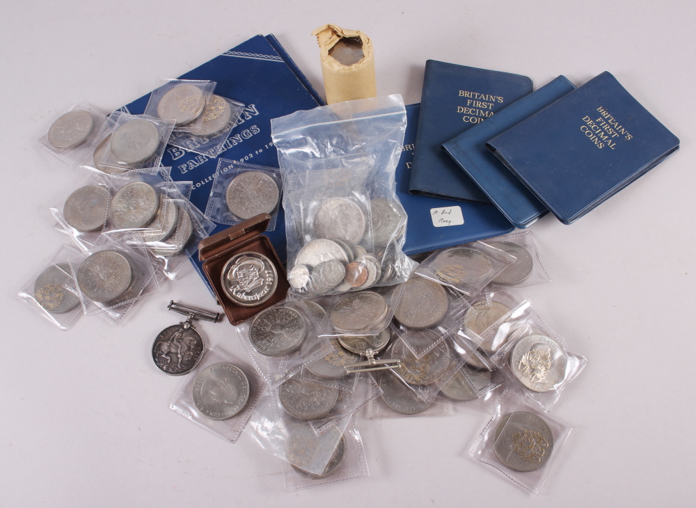 A collection of British pre-decimal coinage, a WWI service medal to 181331 GNR A J Burt RA, and a