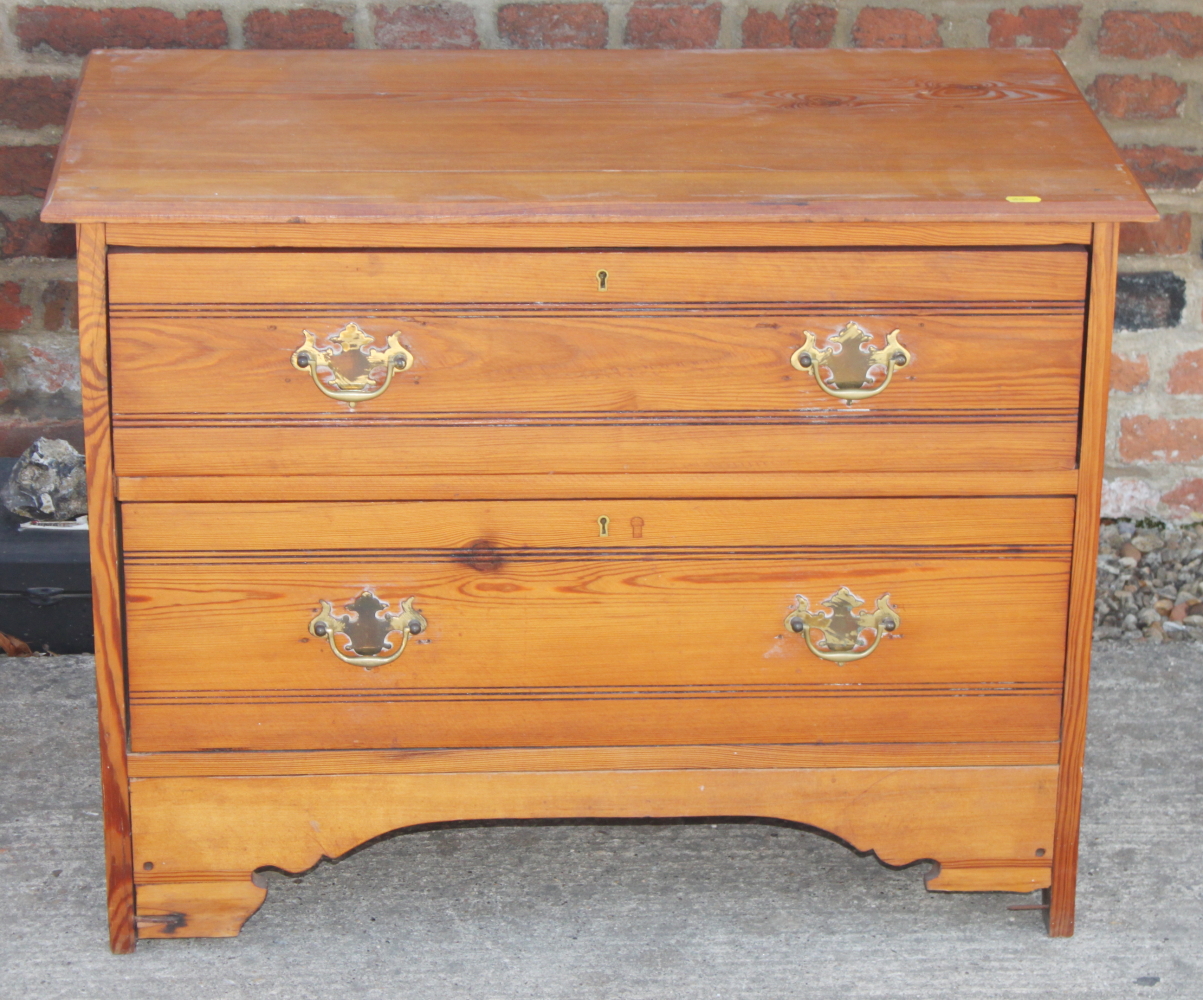 A pine chest of two drawers, 31" wide, and a wicker hamper