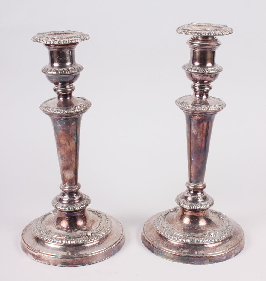 A pair of Georgian design silver plated candlesticks with gadroon borders, 10" high, and an oval