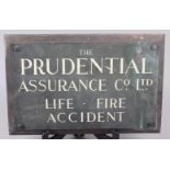 A Prudential Assurance brass name plate, on wooden backboard