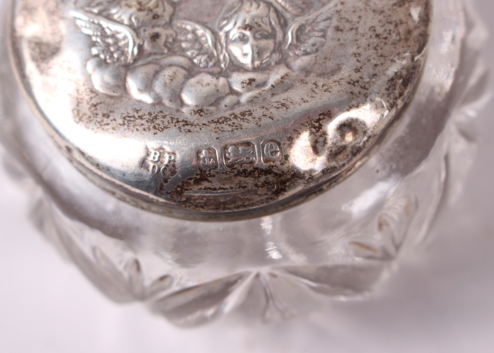 A pair of squat silver candlesticks embossed cherubs' heads, and a similar hand mirror, pin jar - Image 4 of 4