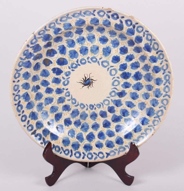 An 18th century Delft plate with all-over leaf and tendril design, 12" dia (rim chips)