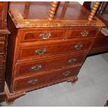 A Georgian walnut and mahogany banded chest of two short and three long drawers with brass