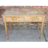 An early 19th century pine side table, fitted two frieze drawers, on turned supports, 39" wide