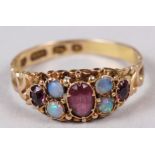 A late 19th century 15ct gold, ruby and opal dress ring with engraved shank, 1.9g, size P