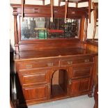 A Victorian walnut mirror back dresser with flanking columns over two drawers and cupboards, on