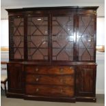 An early 19th century mahogany breakfront library bookcase, fitted astragal beaded glazed doors,