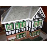 A Tudor style doll's house with part furnished interior, wired for lighting, 23" wide