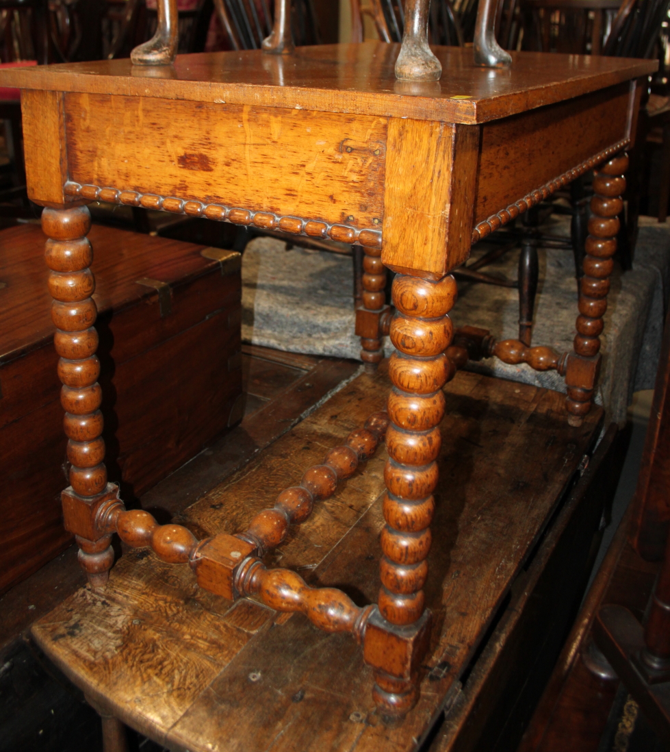 A 19th century oak side table, fitted frieze drawer, on bobbin turned supports, 36" wide