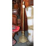 A brass standard lamp with reeded column and three paw feet, 52" high