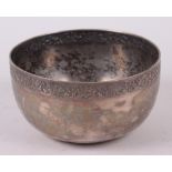 A Thai white metal bowl with engraved rim and base, 6" high