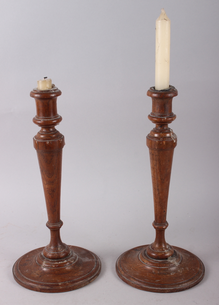 A pair of turned oak candlesticks, 12" high, and three framed landscape prints