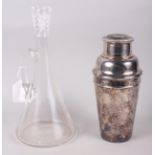 A silver plated cocktail shaker and a glass claret jug