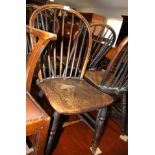 A set of four Windsor hoop and spindle back dark stained kitchen chairs