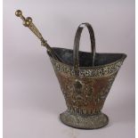 An embossed brass coal bucket and a set of steel fire irons with cast brass handles