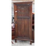 An oak corner hall wardrobe, fitted panelled door, carved linenfold and armorial, 30" wide