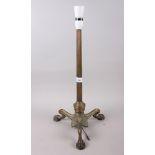 A brass table lamp with reeded column, on three claw feet, 19" high