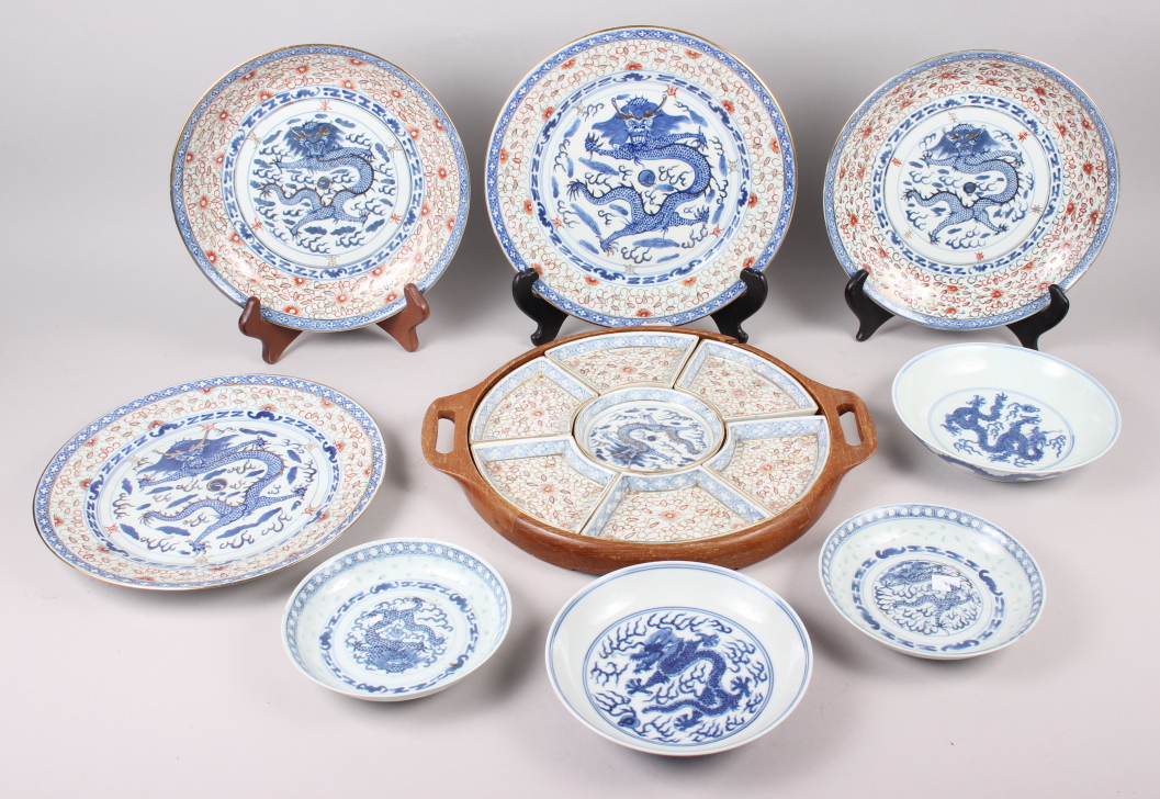 Two Chinese blue and white dragon decorated dishes with six character marks to bases, similar plates