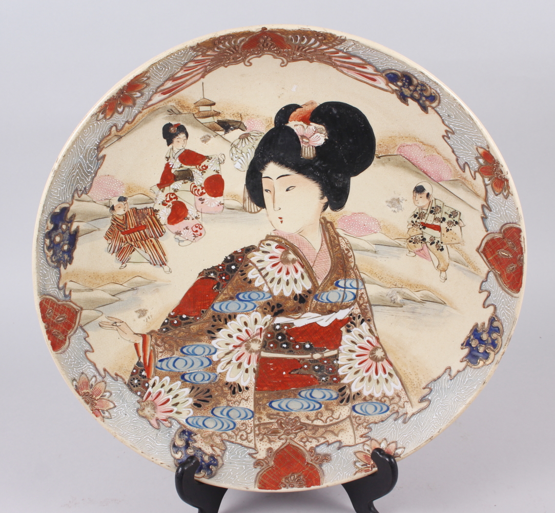 A Satsuma charger, decorated figures in a landscape, 14 1/4" dia