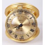 A Jaeger travelling alarm clock with gilt dial and Roman numerals and scrolled and pierced case