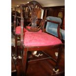 A set of six mahogany shield back dining chairs with pierced splats carved wheat ears, upholstered