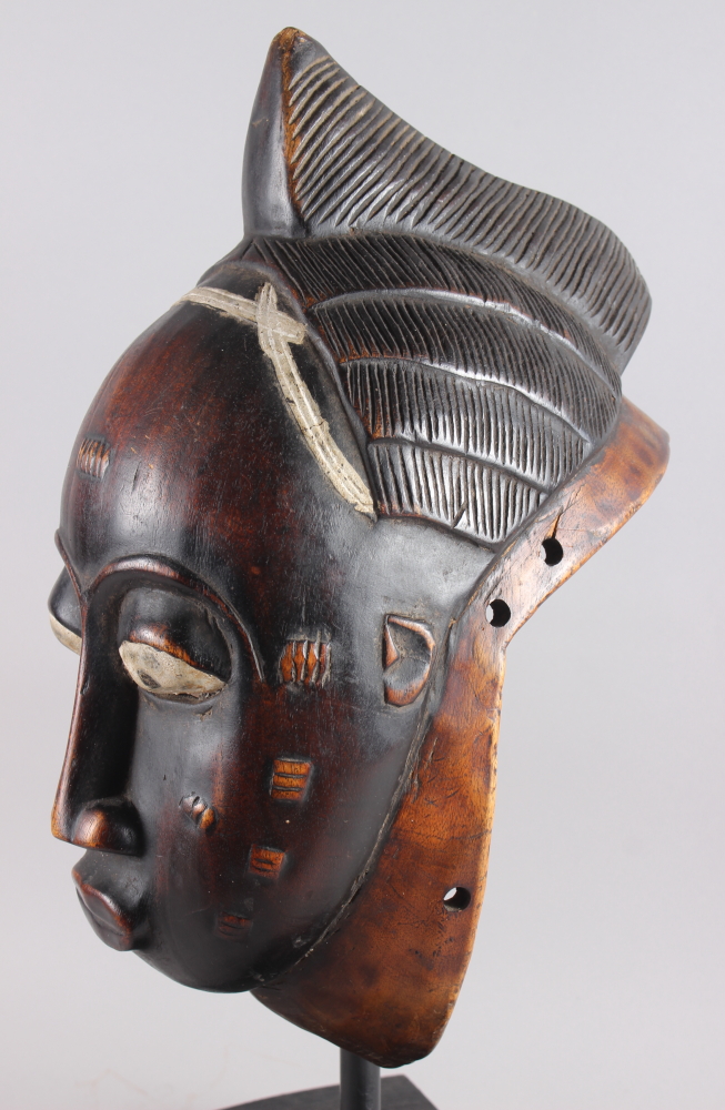 A West African carved hardwood tribal mask, on ebonised stand, 13 1/4" high - Image 3 of 6