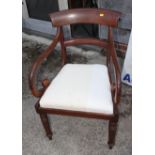 An early 19th century mahogany rail back carver chair with scroll arms, on turned octagonal supports