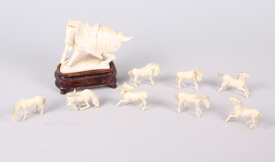A number of carved ivory Emperor's horses, one on hardwood stand
