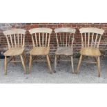 An early 20th century low seat nursing chair, button upholstered in a tapestry fabric, on scroll