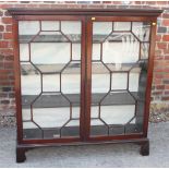 A Georgian design mahogany bookcase enclosed two astragal beaded glazed doors, on bracket