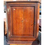 A Georgian oak wall corner cabinet with panelled door inlaid shell, 30" across