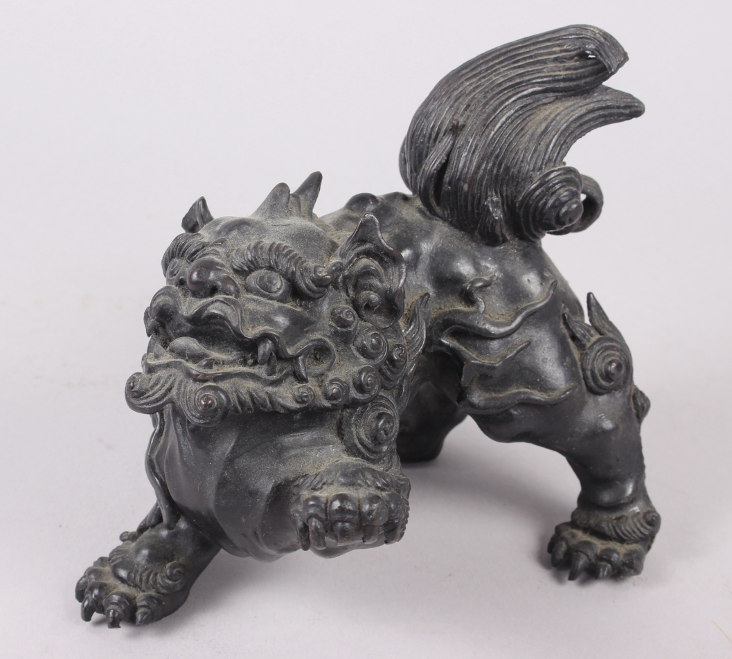 A Chinese bronze model of a lion, 5 1/2" high