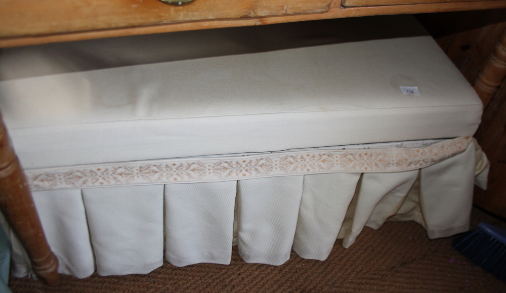 A 19th century white painted pine box-seat ottoman