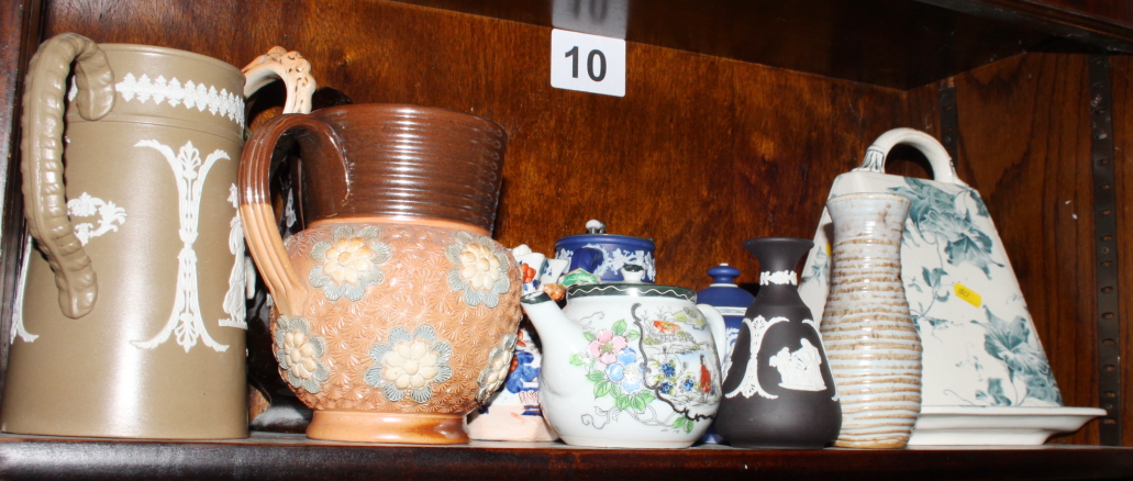 A brown transfer decorated toilet jug, another toilet jug and assorted decorative jugs, etc,