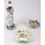 A Chinese polychrome decorated figure of a man holding a sword, a green glazed wall pocket with