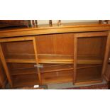 A light oak bookcase enclosed three sliding glazed doors, 77" wide x 14" deep x 45" high