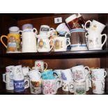 An assortment of commemorative and other mugs