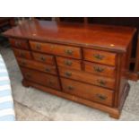 A Georgian design cherrywood chest of eleven drawers, 54" wide