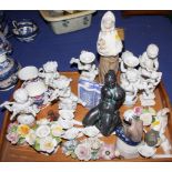 A small Lladro figure of a dozing cherub, a pair of Rosenthal white chine cherub candlesticks, a set