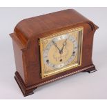 A 20th century mantel clock by Elliott, in walnut case, Westminster and Whittington chimes, 9" high